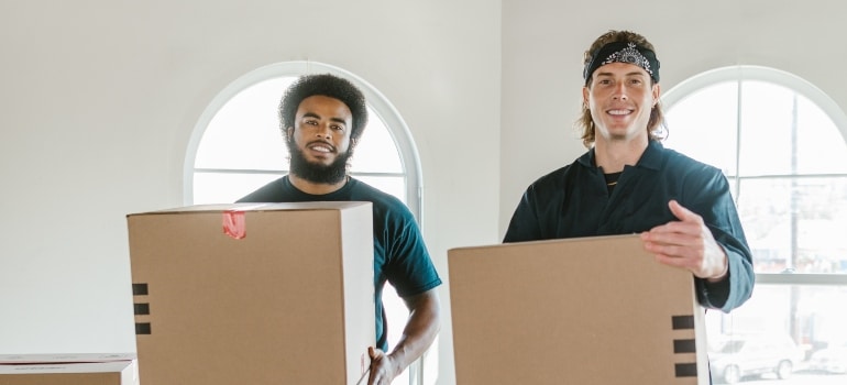 two movers in Los Angeles County holding packing boxes