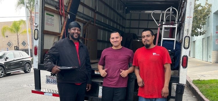International movers California standing in front of a moving truck