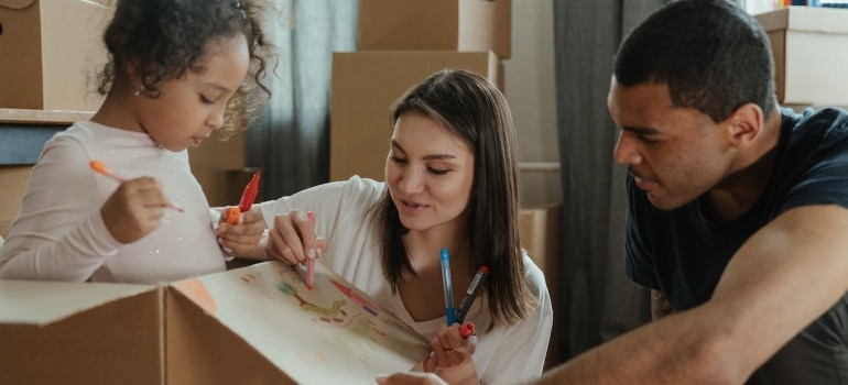 A family drawing on a cardboard box