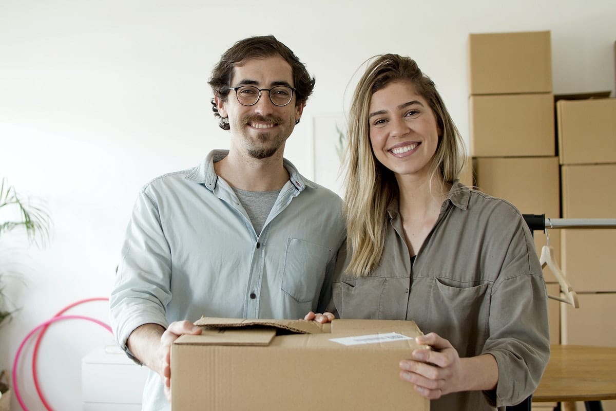 Couple Smiling while Holding the Package.