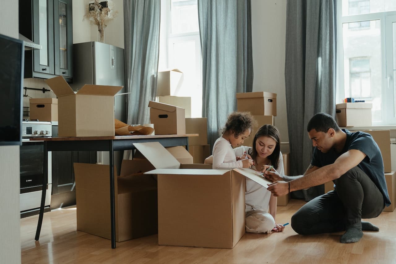 A family packing after understanding the major differences between local moving and long distance moving