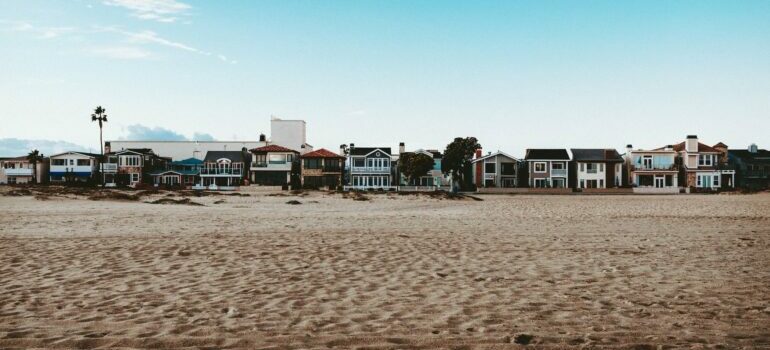 Sandy beach lined with houses in Newport Beach
