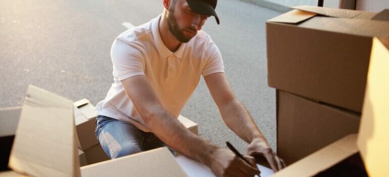 A member of the San Jose movers crew doing inventory of the moving boxes