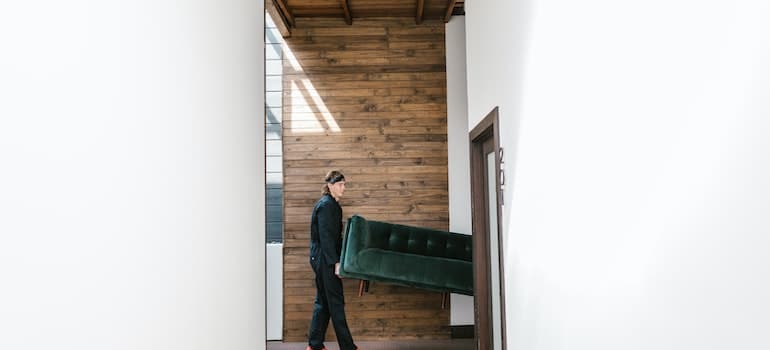 Movers San Francisco offers carrying a green couch through a narrow door