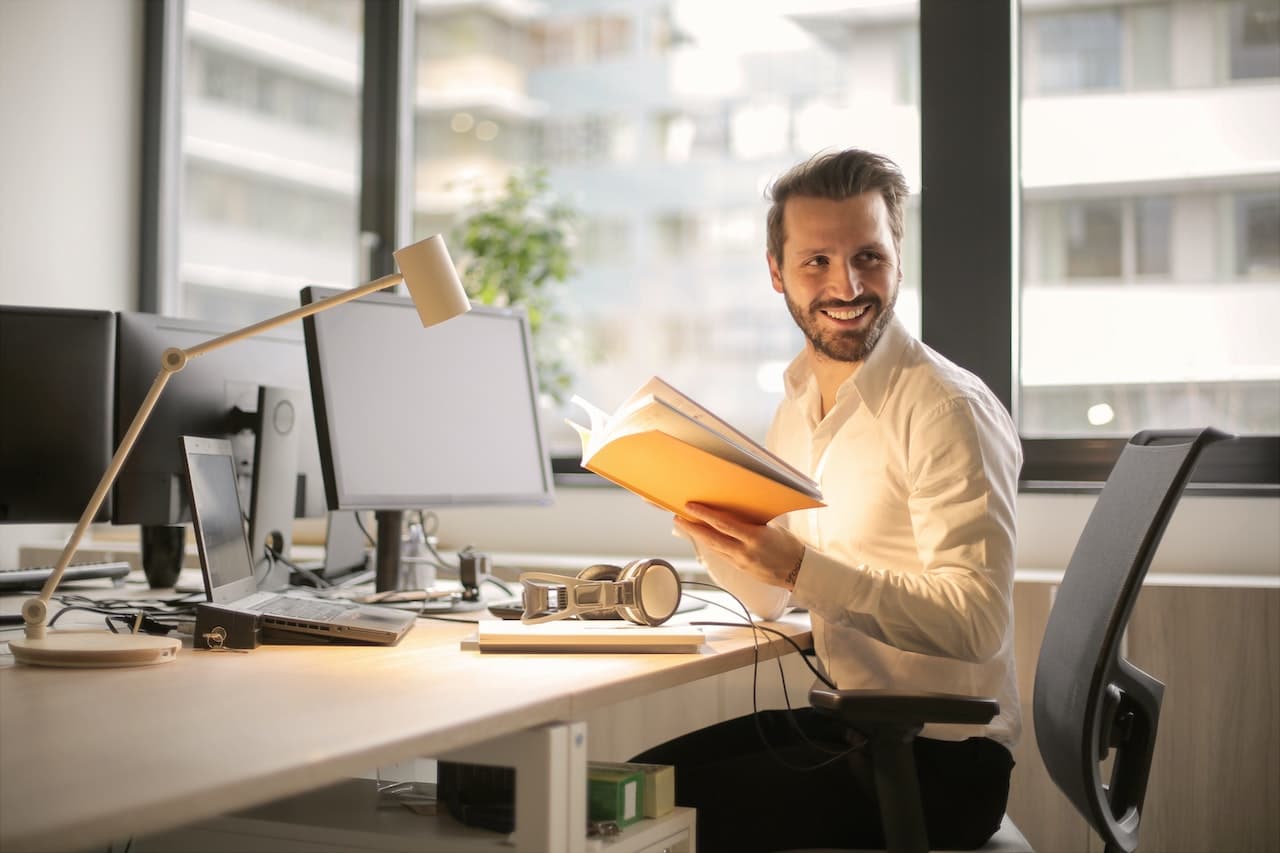 smiling man sitting at his office