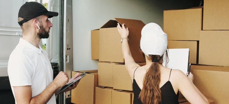 a man and woman packing boxes 