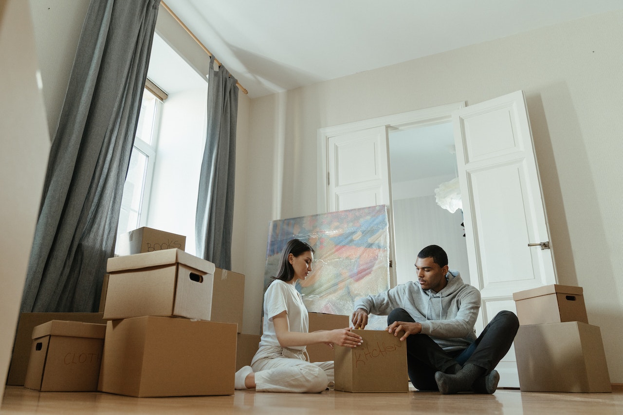 a couple discussing should you hire movers for your relocation from Burbank to Texas?